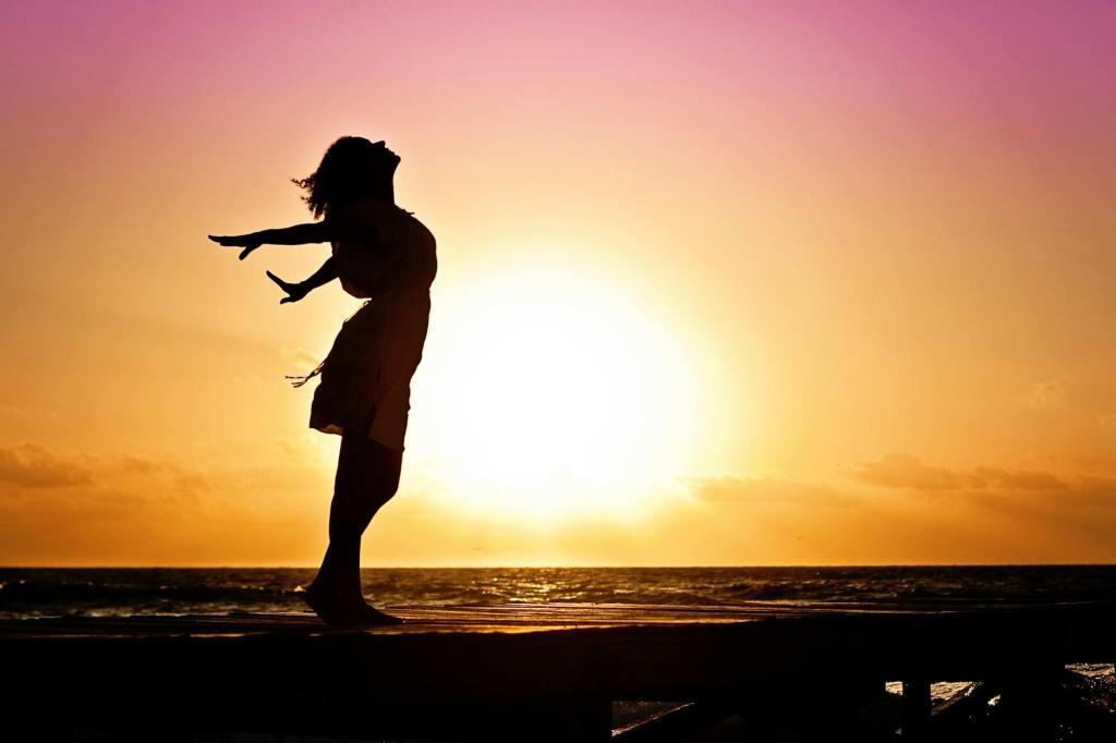 The current image has no alternative text. The file name is: woman-happiness-sunrise-silhouette-40192.jpeg